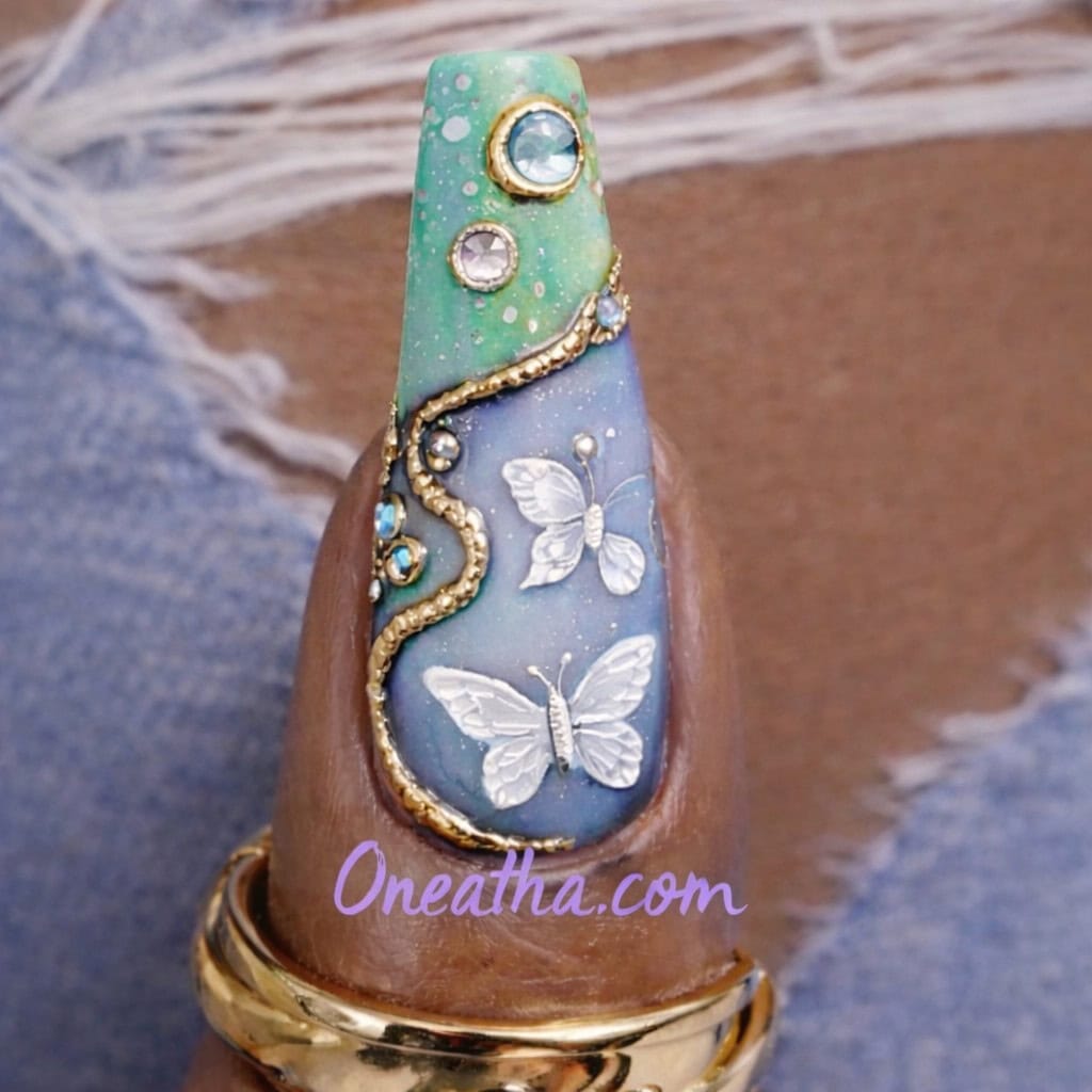 White butterfly nails feature soft, glossy bases with delicate butterfly wing designs that create an elegant and feminine nail look. These nail designs often include gradients, chrome accents, and gemstones to enhance dimension and visual interest. White butterfly nail designs are a trending choice for classy, timeless manicures that work for everyday wear and special occasions.