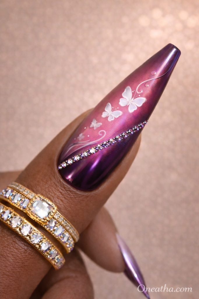 White butterfly nails with glossy finish, soft feminine nail design featuring delicate butterfly art, elegant manicure with butterflies, luxury butterfly nail inspiration, almond and stiletto butterfly nails design.