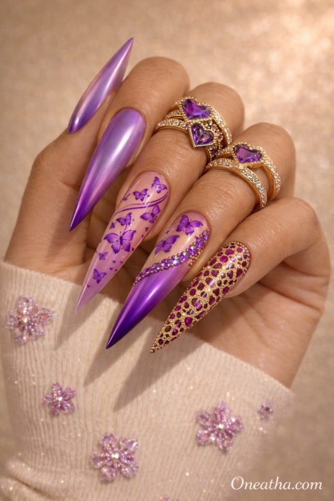 Purple butterfly nails with chrome finish, nude base, rhinestone accents, gold textured accent nail, glossy stiletto acrylic nails with butterfly nail art on a warm-toned hand with gold rings, luxury nail inspiration