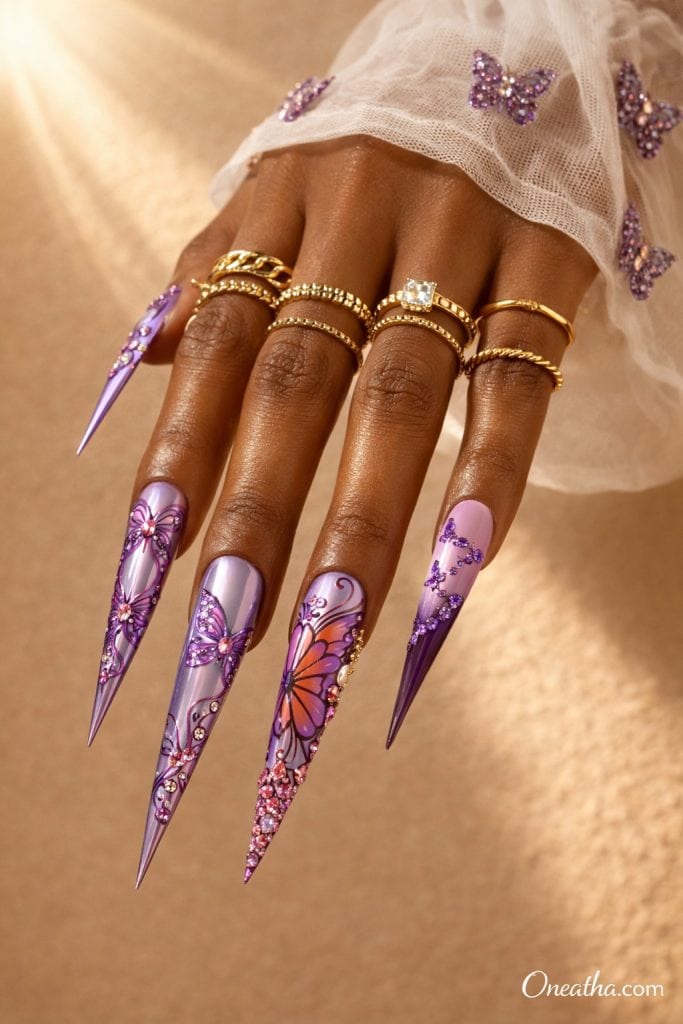 Purple butterfly nails with ombre lilac and deep purple tones, rhinestone accents, glossy stiletto acrylic nails, butterfly nail art design on warm-toned hand with gold rings, luxury nail inspiration