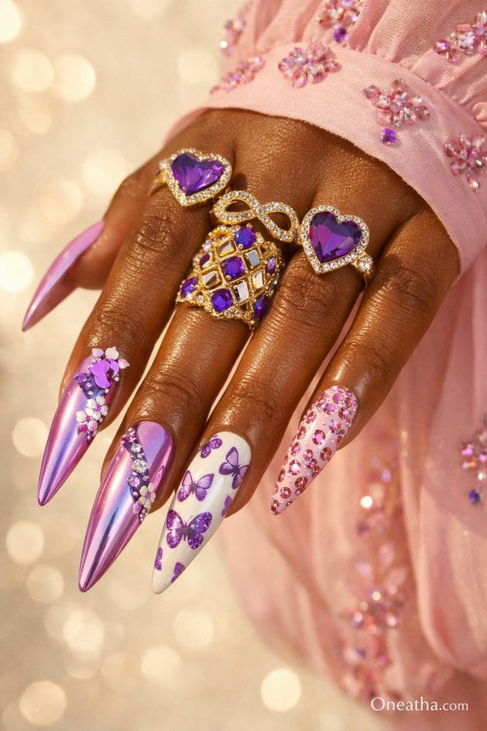 Purple butterfly nails with pink chrome finish, rhinestone accents, butterfly nail art, glossy stiletto acrylic nails, mixed design nails with shimmer and crystals on warm-toned hand with gold rings, luxury nail inspiration