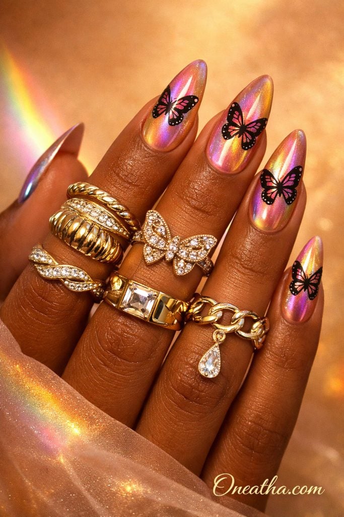 Purple butterfly nails with holographic chrome finish, iridescent rainbow nails, glossy almond acrylic nails, butterfly nail art design, luxury chrome nails on warm-toned hand with gold rings, high shine nail inspiration