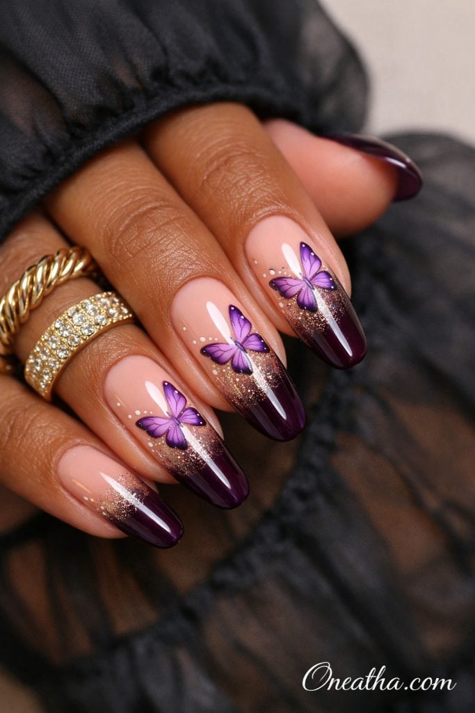 nude to plum ombre purple butterfly nails with gold shimmer tips, glossy almond shaped nails with violet butterfly nail art, elegant luxury purple nail design inspiration