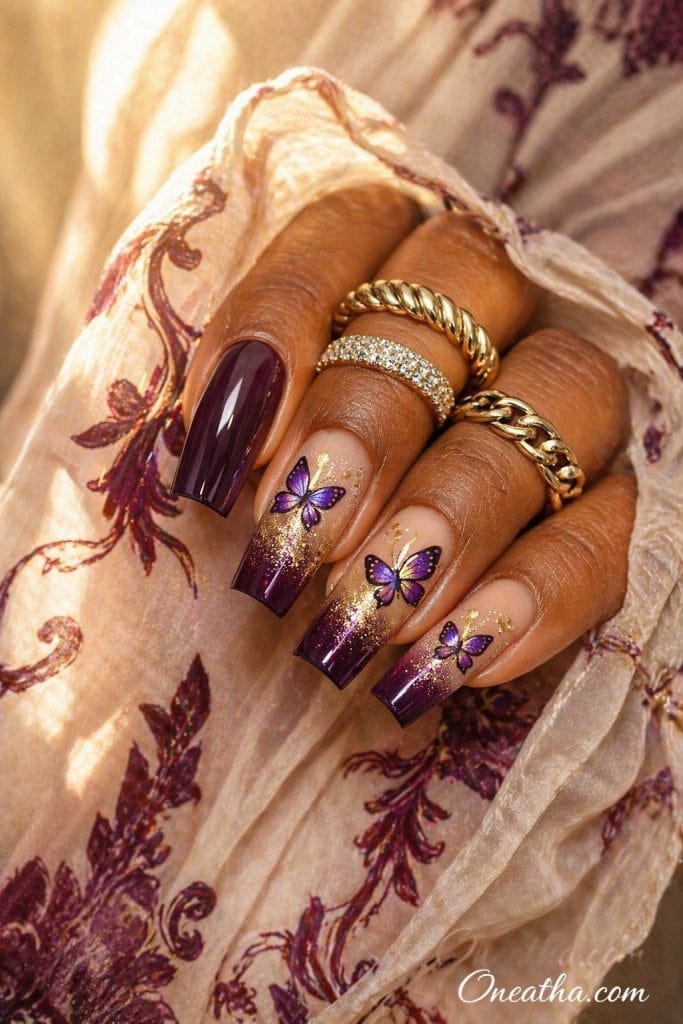 purple butterfly nails with plum ombre tips and gold glitter accents, square acrylic nails with nude base and glossy finish, elegant luxury purple nail design inspiration