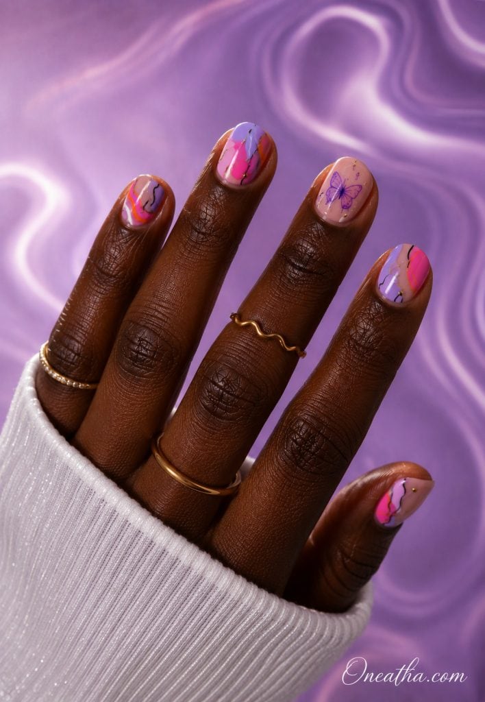 Short butterfly nails with a purple butterfly accent by Oneatha.