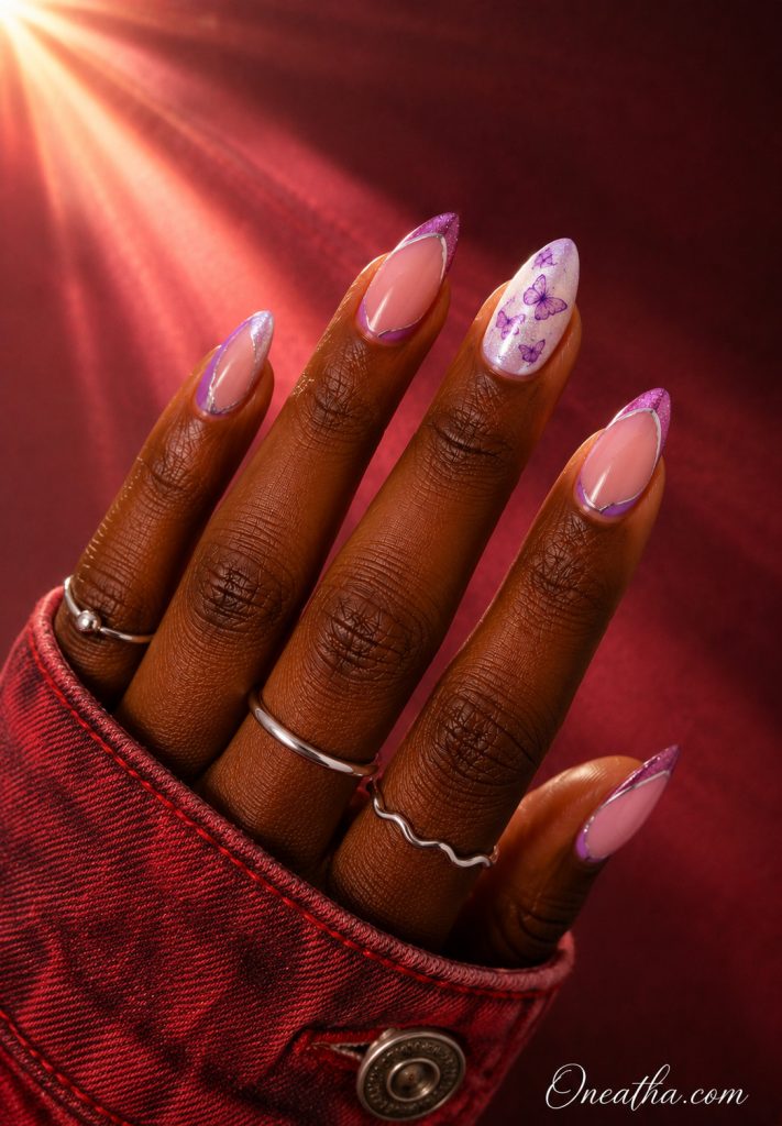 Luxe Violet almond nails with purple butterfly art by Oneatha.