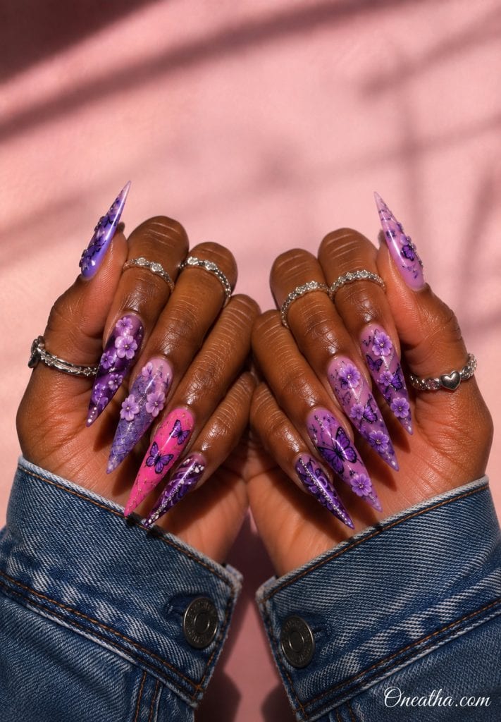 Purple butterfly floral stiletto nails.