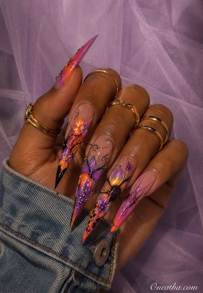 Purple butterfly floral stiletto nails.