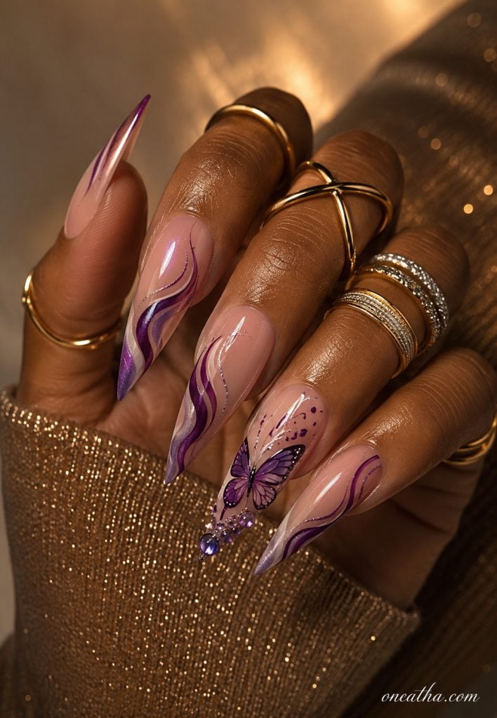 Purple butterfly stiletto nails with flowing swirl accents.