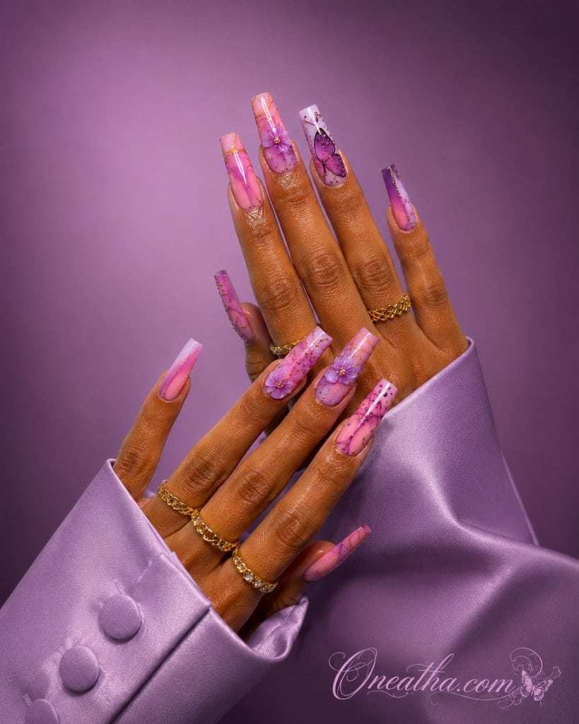 Luxury lilac butterfly nails with 3D flowers and glossy pink aura accents.