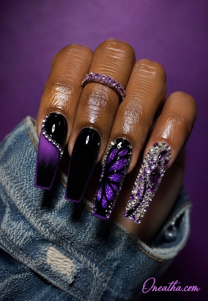 Purple butterfly wing accent nail with sparkling gemstones.