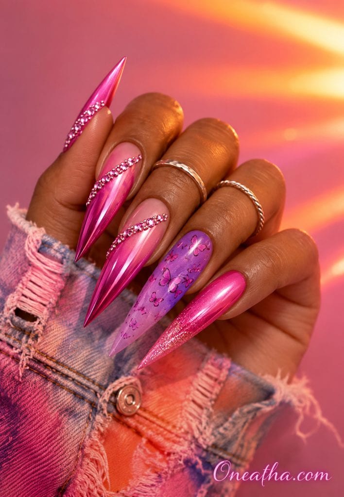Pink chrome stiletto nails with a purple butterfly accent nail, silver rings, and a sunset pink luxury background.