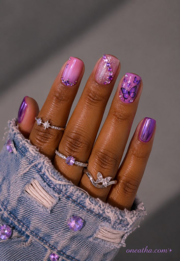 Short lilac chrome butterfly nails with purple crystal accents.