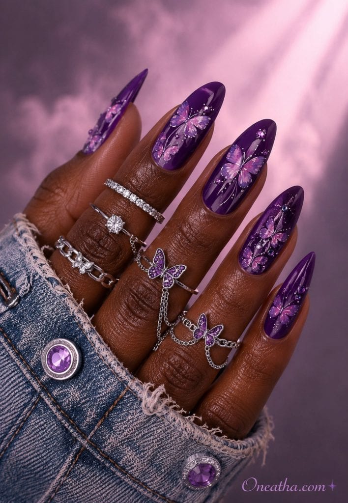 Glossy violet butterfly nails with silver butterfly rings.
