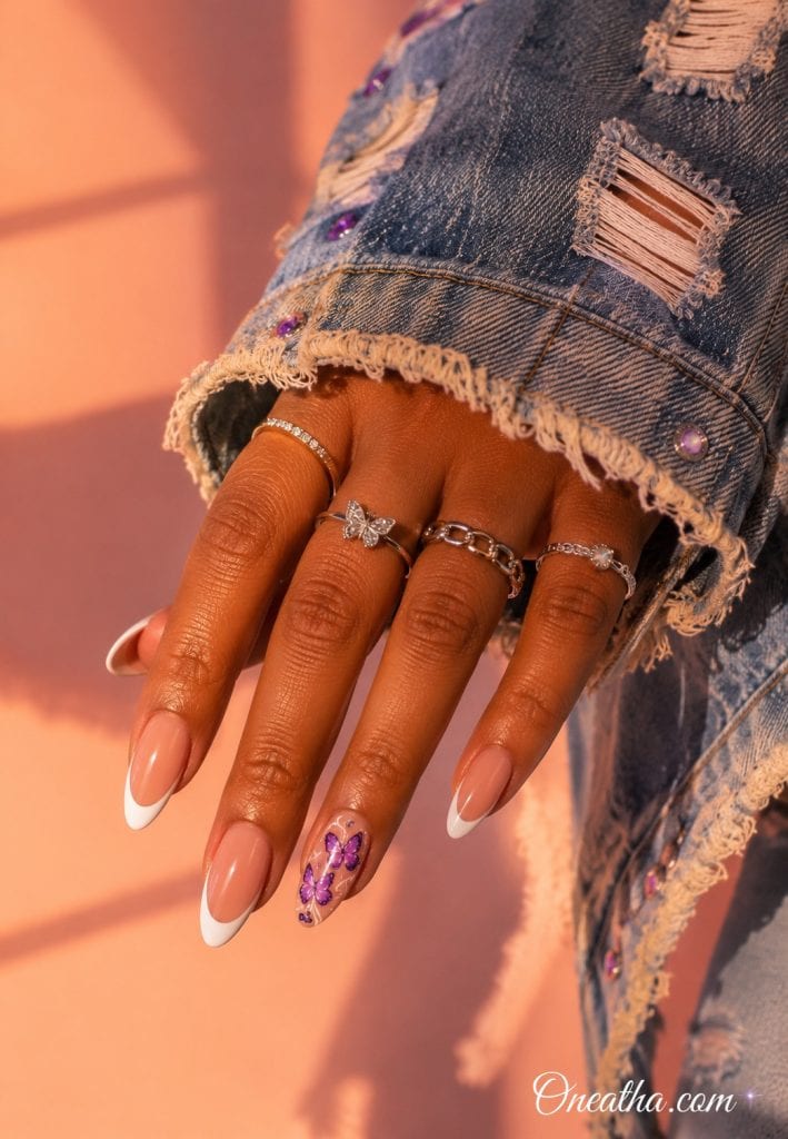 Almond butterfly French tip nails with purple accents.