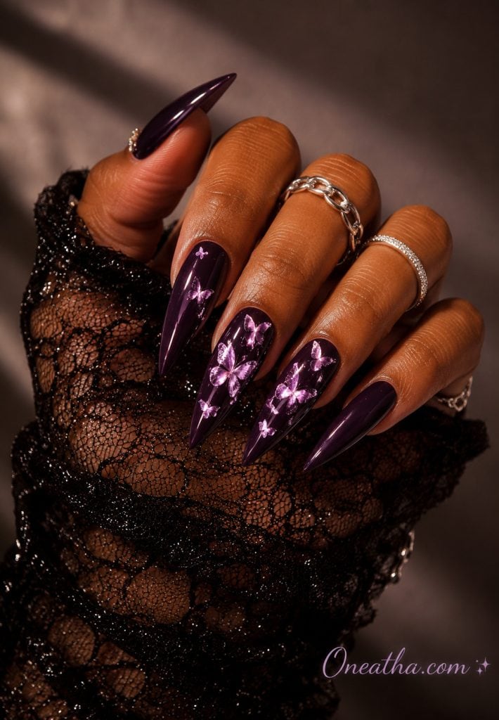 Glossy violet stiletto butterfly nails with a luxurious finish.