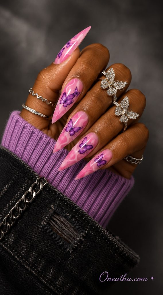 Glossy purple swirl nails with a playful design.
