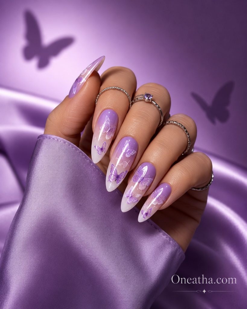 Purple butterfly ombre nails with lavender to white gradient, almond-shaped nails, chrome shimmer accents, butterfly nail art, luxury manicure inspiration by Oneatha, purple aura nails, feminine nail design, elegant butterfly nails