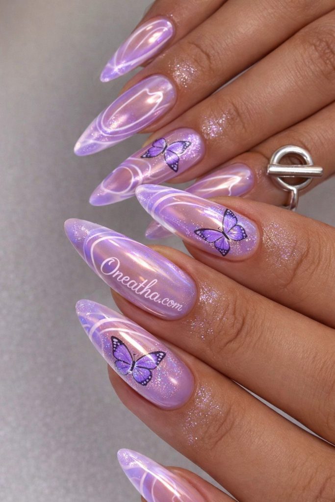 Purple butterfly nails with lilac chrome aura gradient and pearl shimmer tips, featuring butterfly nail art and glowing luxury details on warm-toned hands, Oneatha butterfly nail design, butterfly nail art inspiration, purple lilac chrome nails aesthetic.