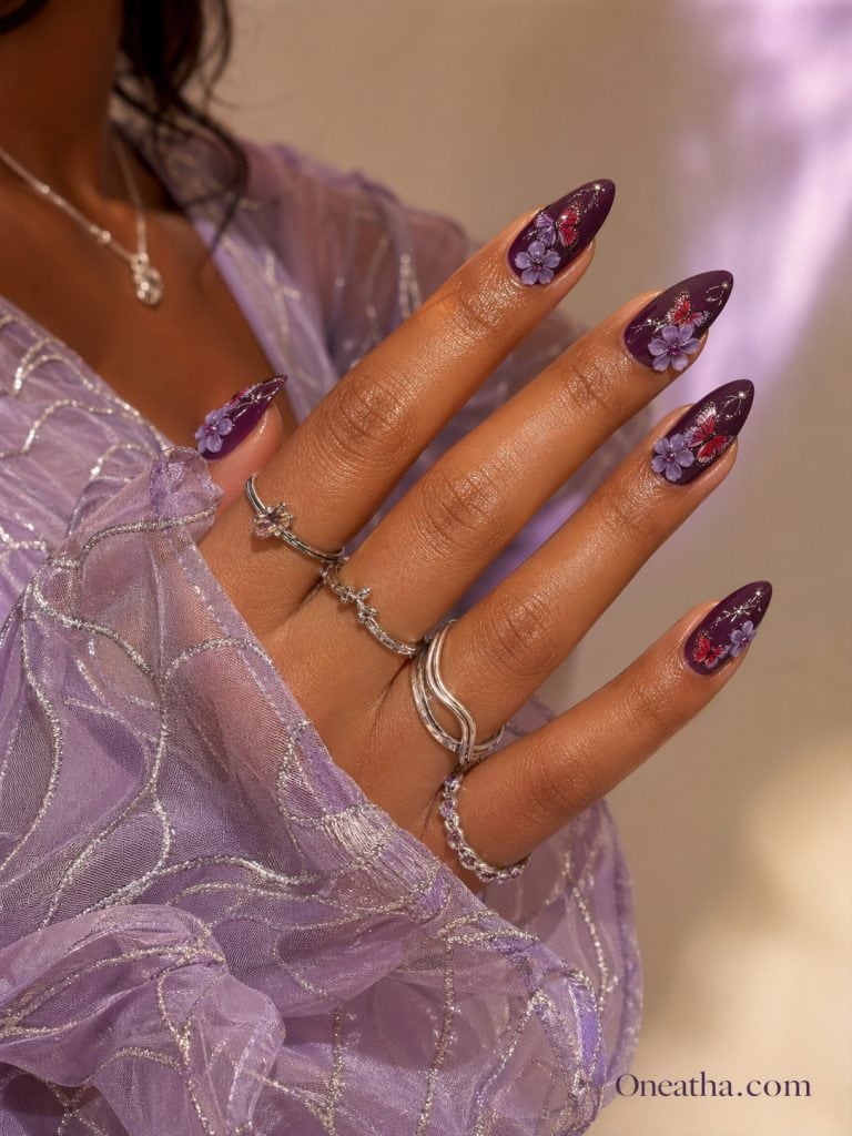 Oneatha Violet Wings luxury almond nails featuring two-tone butterfly nail art that fades from deep plum purple into bold plum sparkle red. Elegant purple floral detailing, glossy finish, feminine butterfly accents, luxury summer nail design, high-end nail inspiration, glamorous almond-shaped nails, purple sparkle nail art, Oneatha signature nail style.