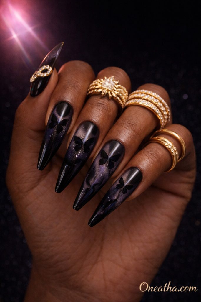 Black cat eye butterfly nails with velvet shimmer and hidden butterfly shapes on long almond nails. Glossy black butterfly nail design with magnetic effect and a luxe, dimensional finish.
