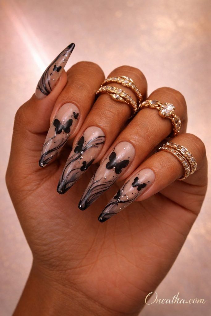 Abstract black butterfly nails with fluid line designs and negative space on coffin-shaped nails. Modern butterfly nail design with soft detailing, glossy finish, and artistic luxury style.