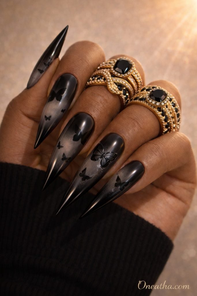 Black butterfly nails with aura gradient fading from black into smoky gray on long coffin nails. Elegant black butterfly nail design with a soft blended effect and glossy luxury finish.