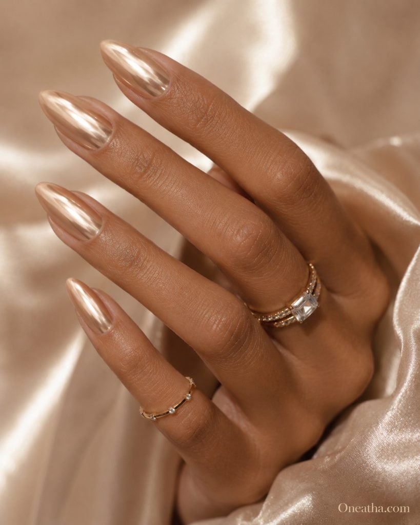 Nude chrome almond nails with reflective luxury shine styled by Oneatha for modern elegant date night and evening beauty looks.