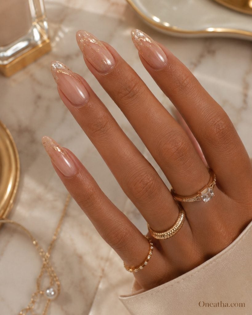 Nude glow nails with gold luxury accents styled by Oneatha showcasing elegant feminine aesthetic and timeless soft glam beauty design.