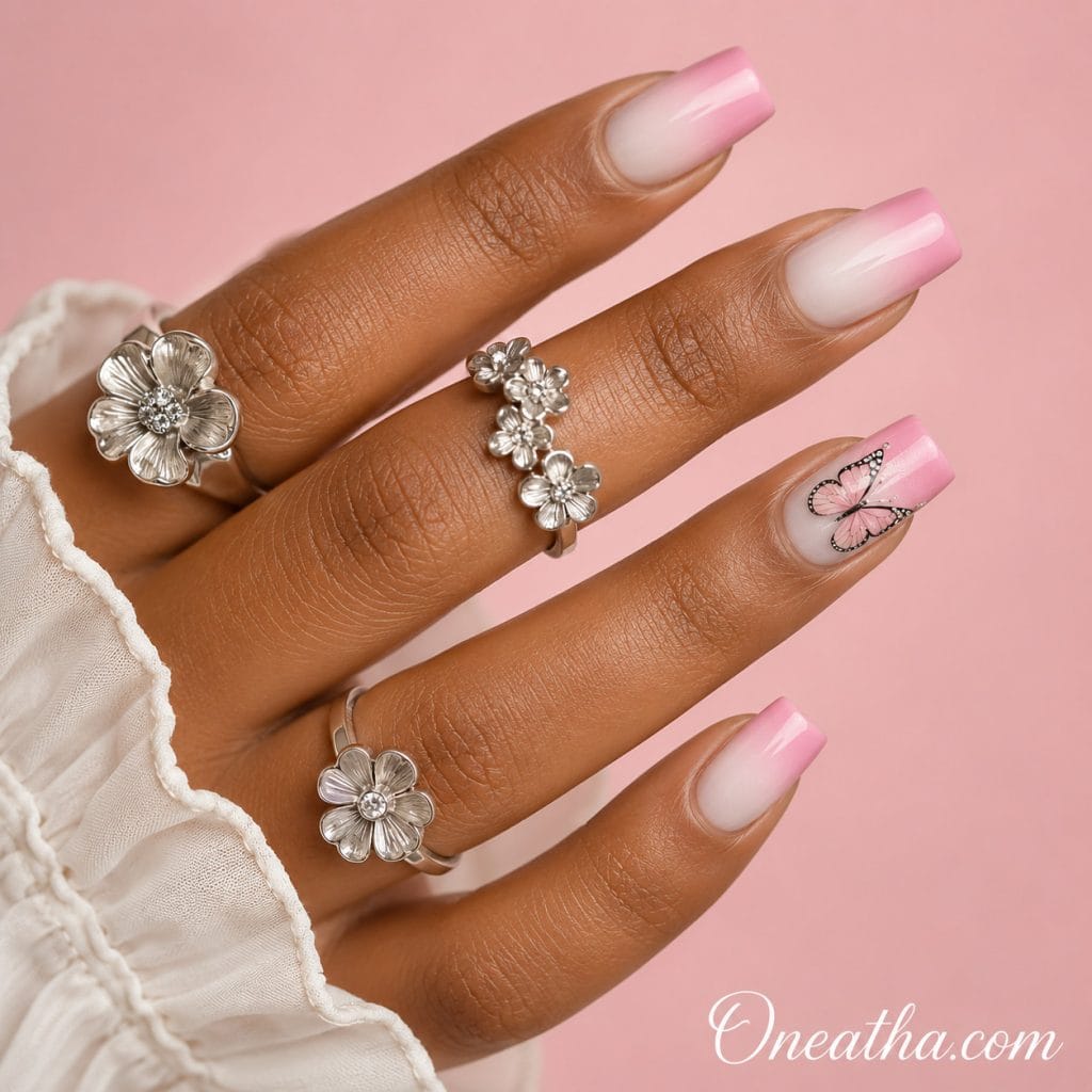 Butterfly nail designs by Oneatha featuring pink ombre butterfly nails with soft pink and white blending, elegant seasonal nail design perfect for spring and summer inspiration.