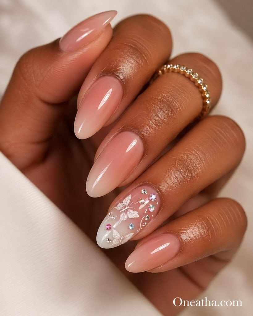 Summer butterfly nail designs by Oneatha featuring elegant almond-shaped nails with high-gloss ombré polish, soft dreamy tones, and a classic feminine finish inspired by butterfly nail aesthetics