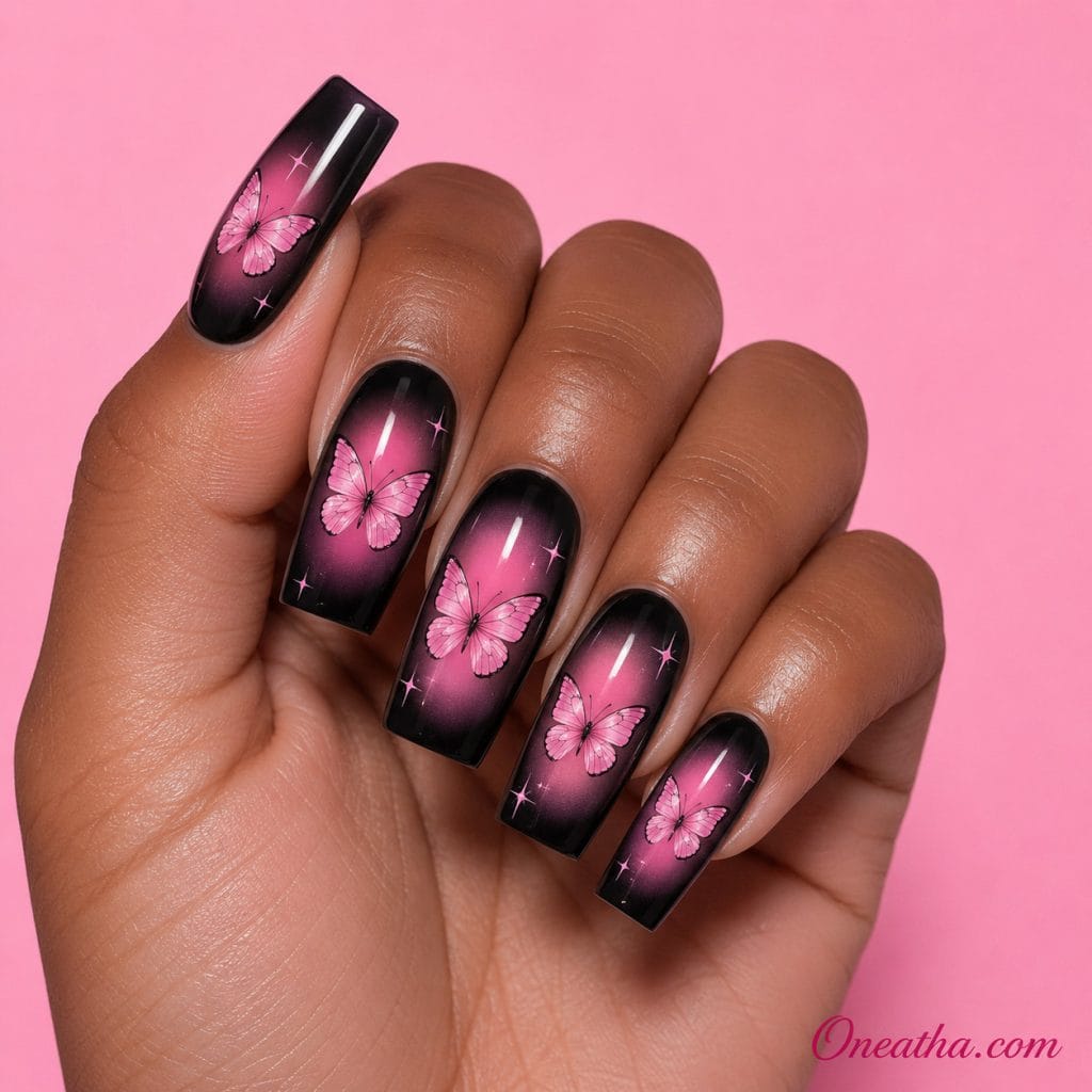 Butterfly nail designs by Oneatha featuring pink butterfly nail art with smoky black and pink aura nails, artistic airbrush-inspired detailing, and a beautiful contrast of dark and light tones.