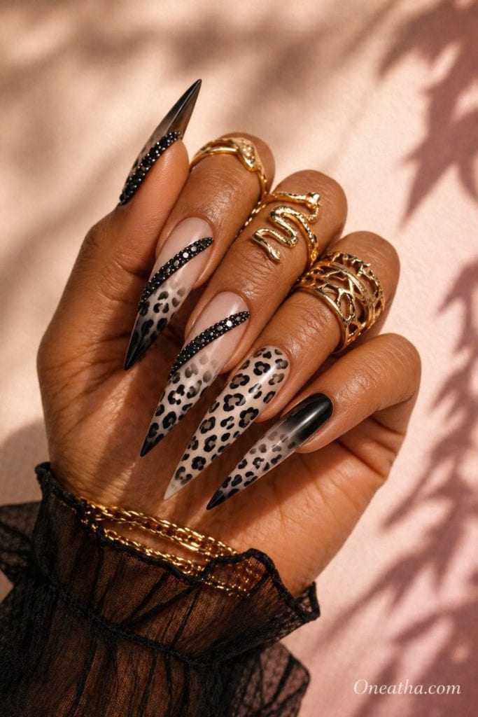 Black and white leopard nails by Oneatha featuring stiletto-shaped nails with bold monochrome leopard print, glossy finish, and a luxury edgy aesthetic.