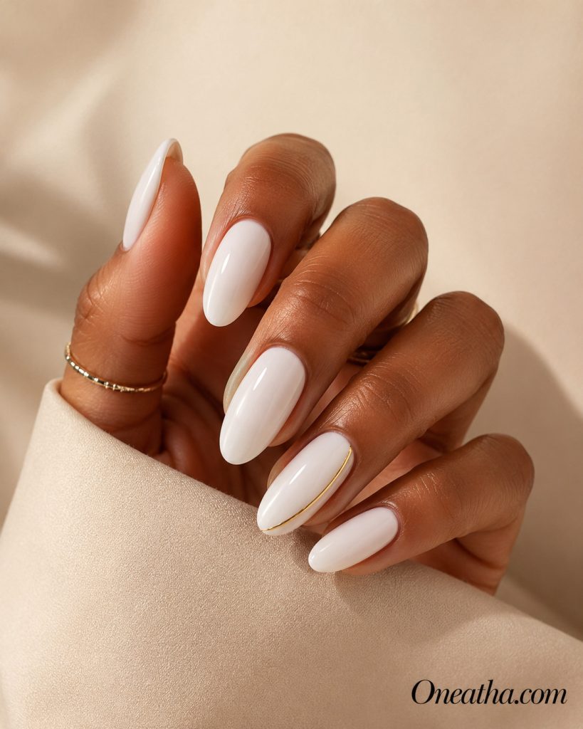 Luxury nail designs by Oneatha featuring stunning milky white almond nails with a glossy finish. These elegant minimalist nails offer a clean, sophisticated look that's perfect for everyday luxury and timeless style.