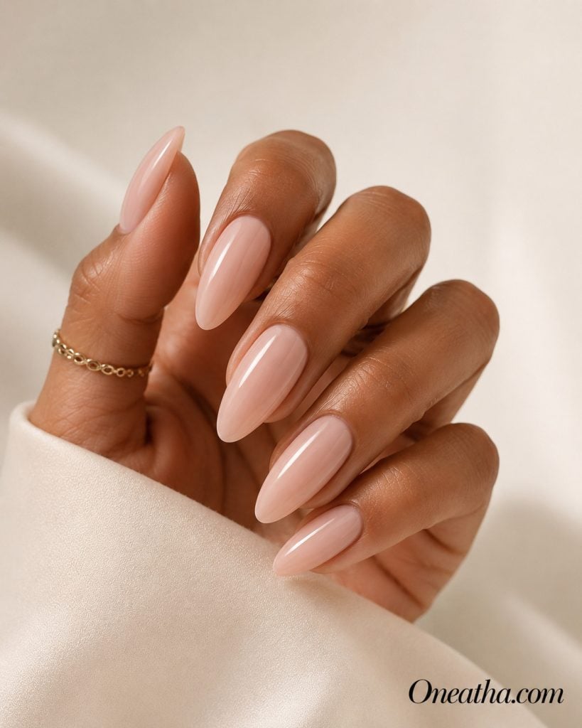 Luxury nail designs by Oneatha featuring soft pink ballet-inspired almond nails with a glossy finish. This elegant minimalist manicure is perfect for summer, weddings, special occasions, and everyday luxury.