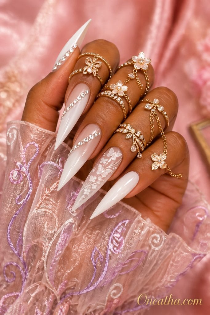Butterfly nail designs by Oneatha featuring a luxe set with a scattered butterfly accent nail, long white glossy stiletto nails, and elegant salon-style detailing designed for special occasions, summer glam looks, and elevated fashion inspiration.