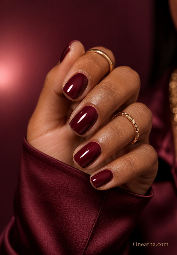 Glossy burgundy short nails.