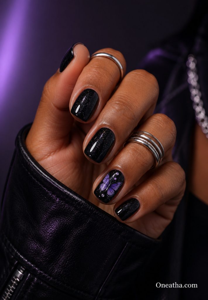 Black sparkle butterfly nails.