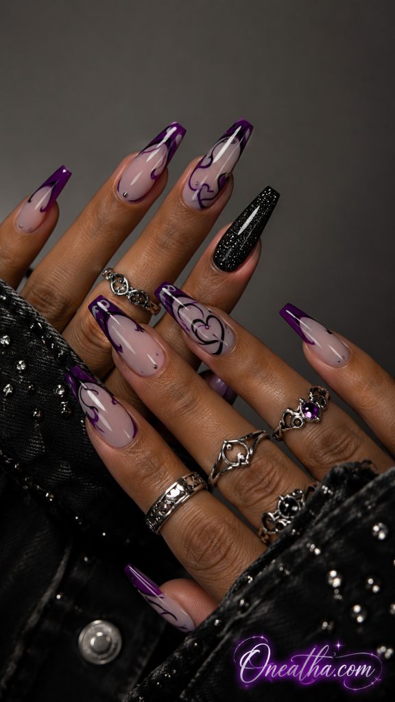 Long glossy coffin nails by Oneatha featuring a sheer blush pink base, deep violet French tips, abstract black heart-line artwork, one black glitter accent nail, silver statement rings, and a black embellished blouse against a luxury neutral background.