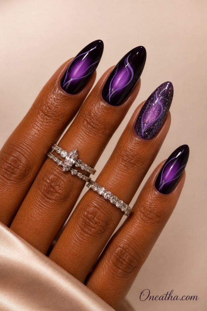 Electric Violet nail design by Oneatha featuring glossy almond-shaped black and violet aura nails with delicate lilac line art, a glittery purple accent nail, silver rings, and a luxe neutral background.