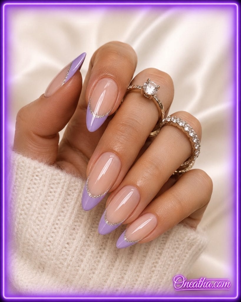 Glossy lilac French tip nail design by Oneatha featuring elegant almond-shaped nails with a soft, luxurious finish.