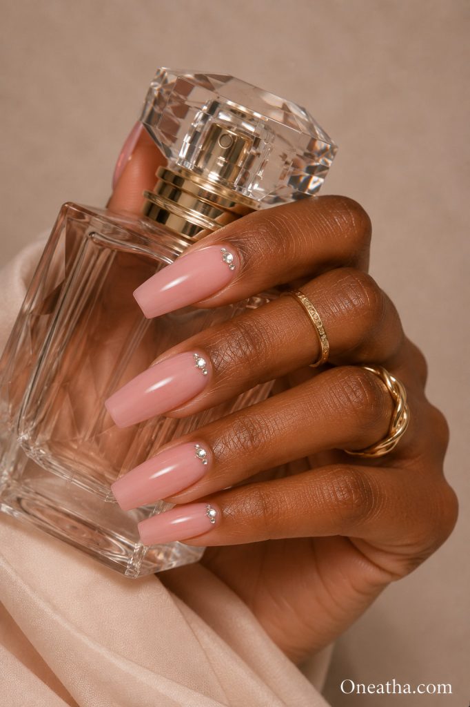 Pink nails with crystal accents.