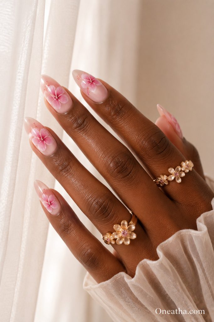 Pink hibiscus floral nail design.