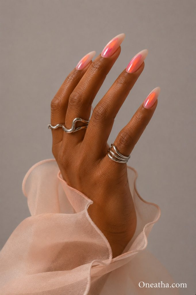 Sunset aura pink almond nails.