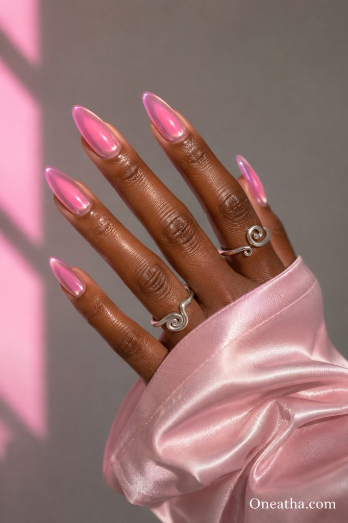 Pink chrome aura almond nails with glossy finish.